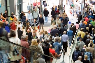 A crowded mall offers many opportunities for entertainment on spring break shopping trips