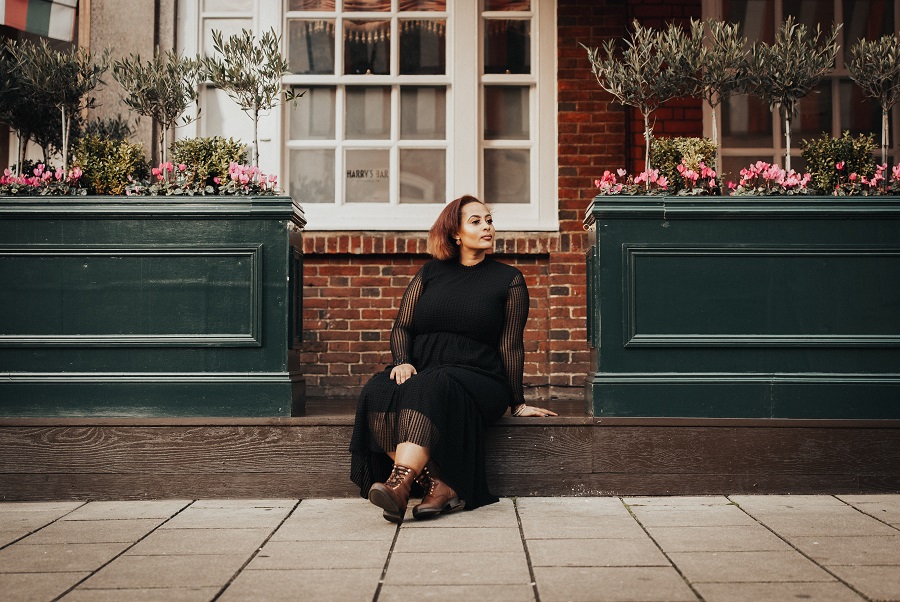 woman in black dress and brown boots