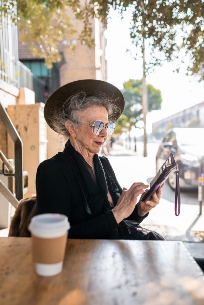 Senior using her mobile app for her life alert system